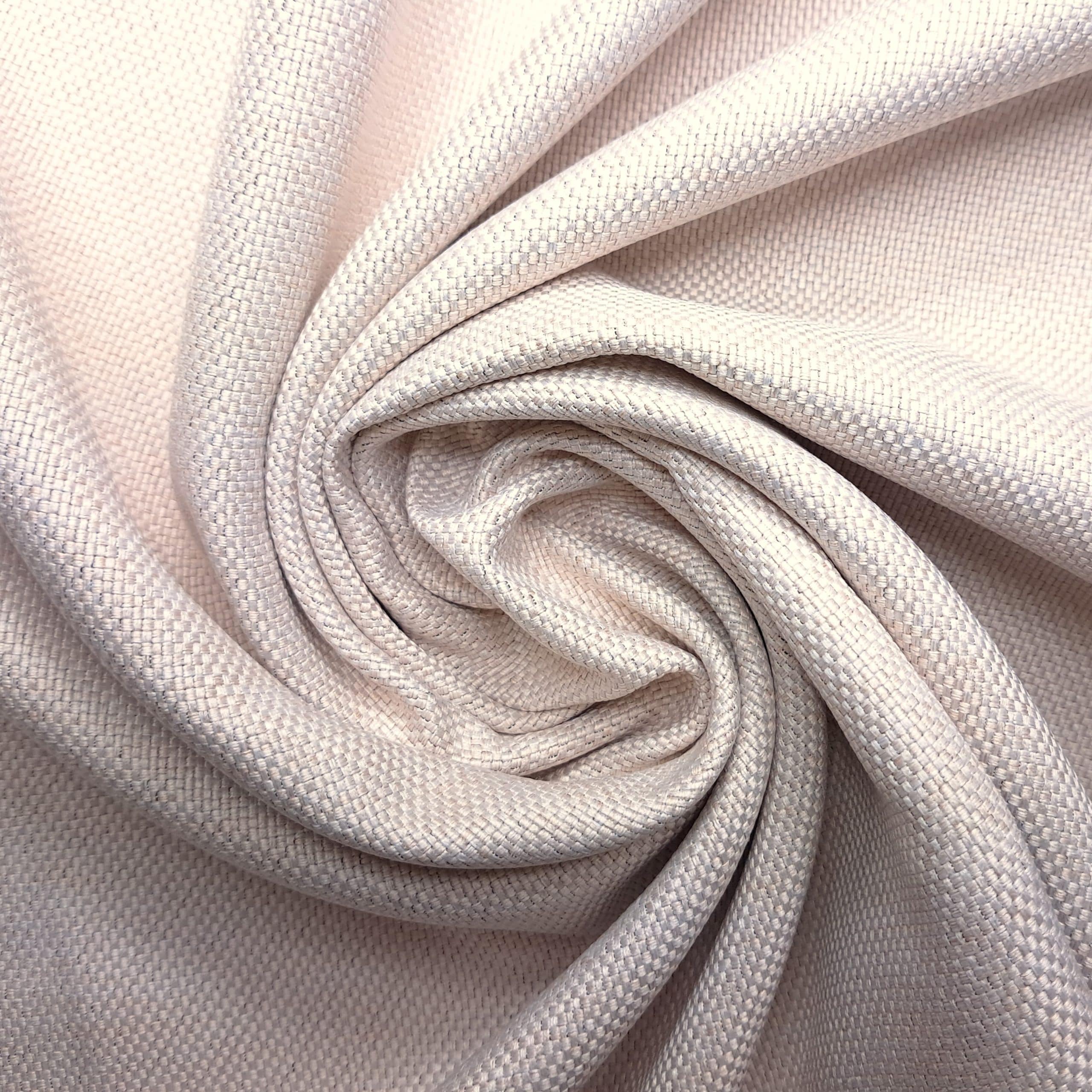 Zbliżenie na teksturowaną jasnobeżową tkaninę z detalami splotu w formie spiralnej.