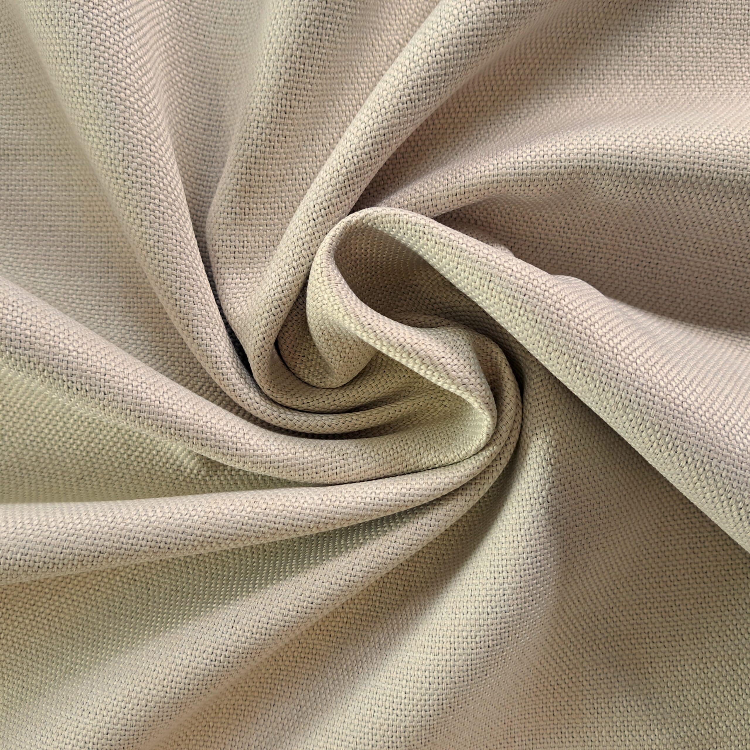 Zbliżenie na miękki, kremowy materiał złożony w artystyczne fałdy, tworzący przytulny wzór.